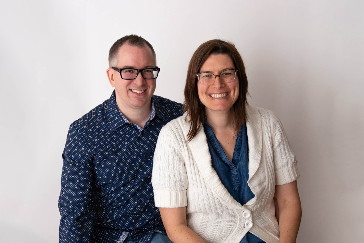 Anneliese and Dustin reviewing advertising performance together at a home office laptop
